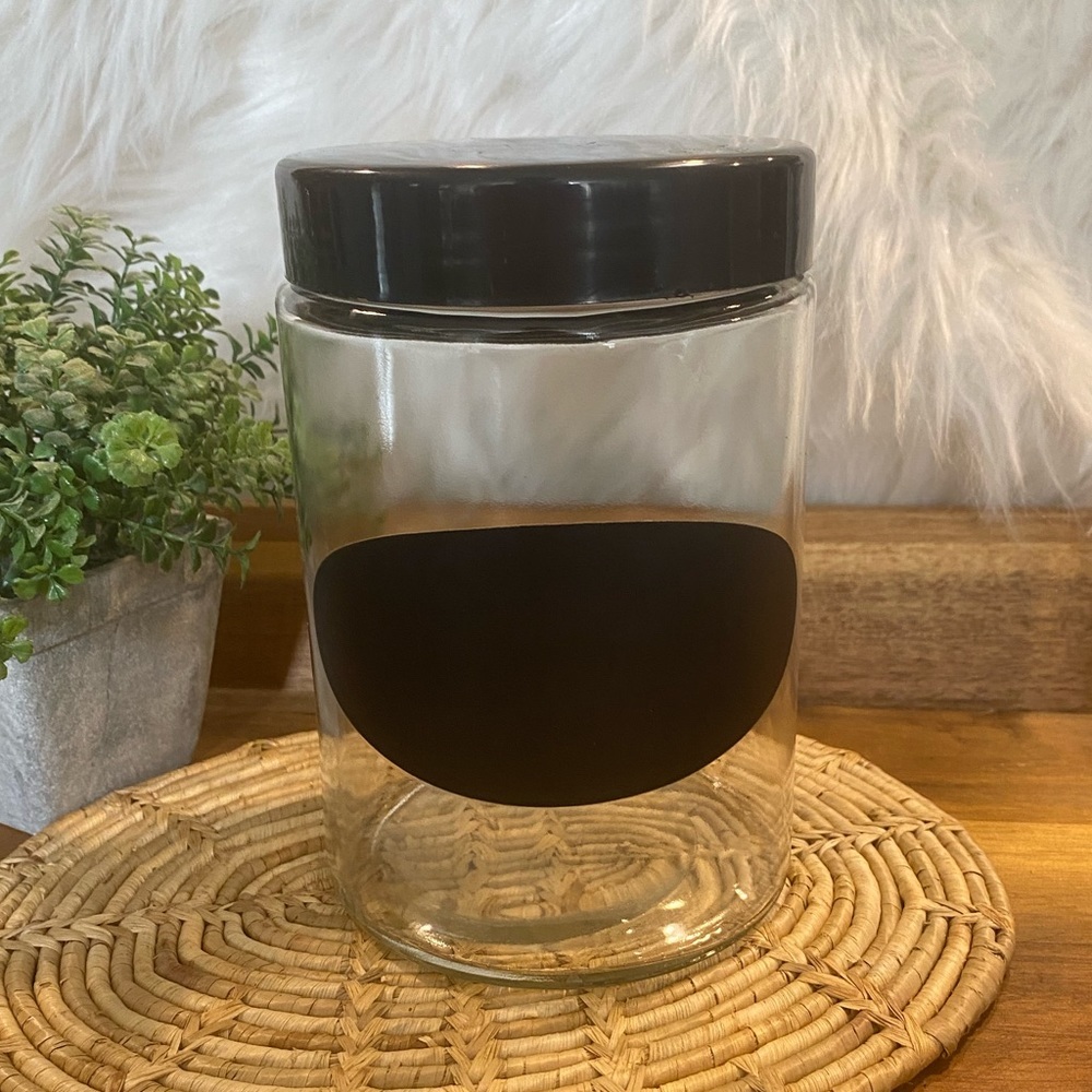 Clear canister with black lid and chalkboard label